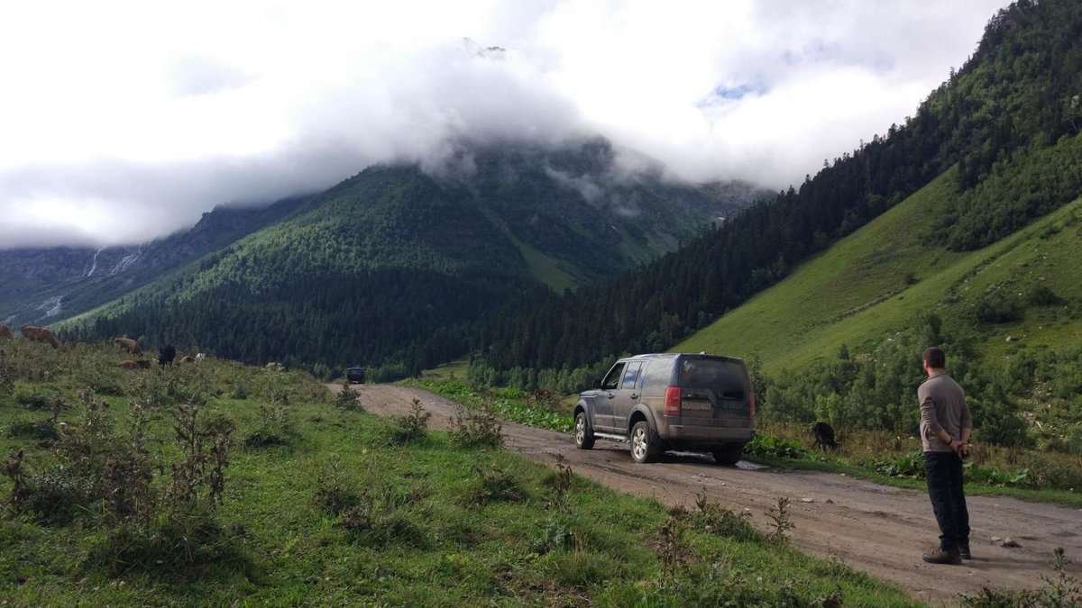 SUV on a dirt road among the mountains
