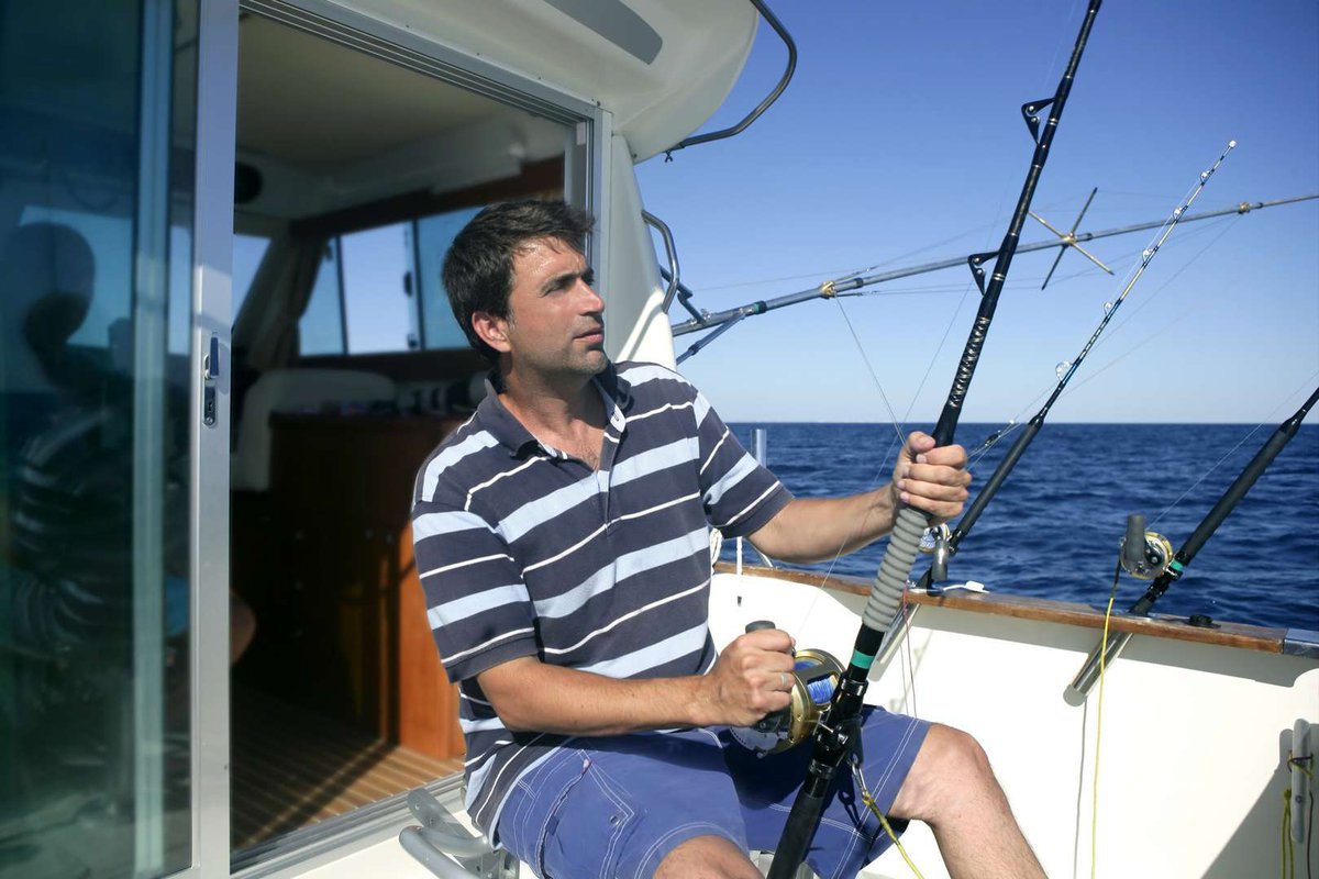 man fishing on a yacht