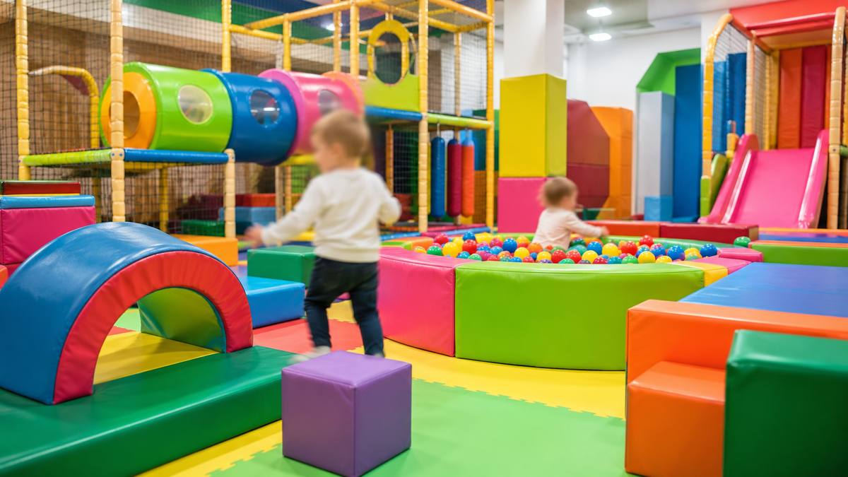 A colourful indoor soft play area for children.
