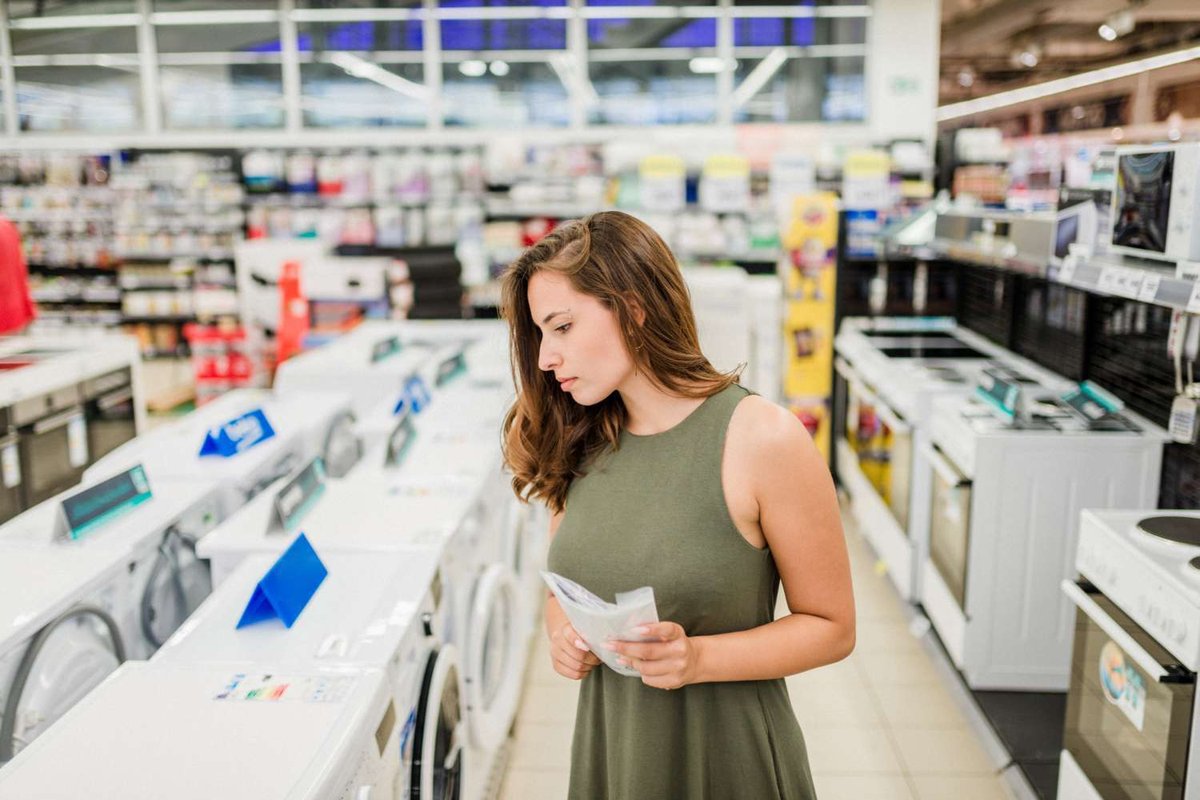 A girl chooses a washing machine