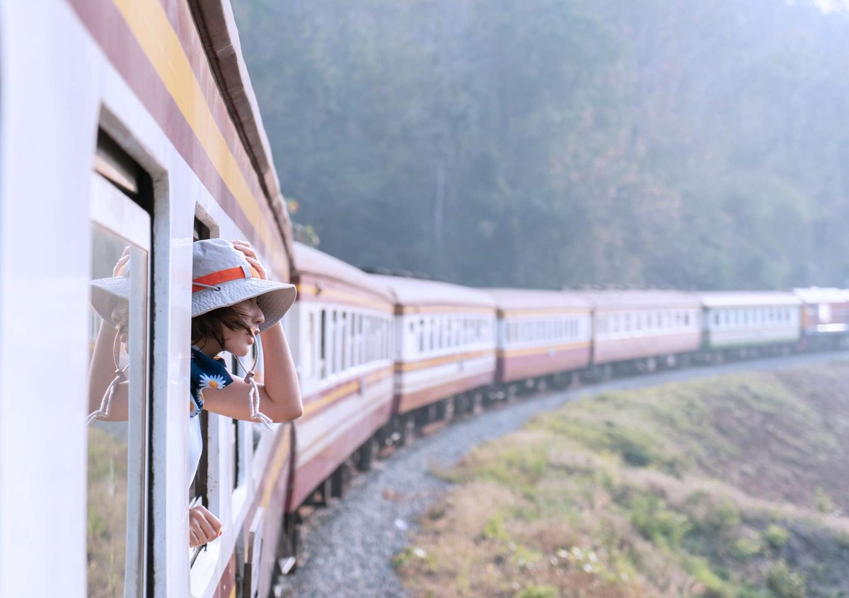 A woman looks out of a train window