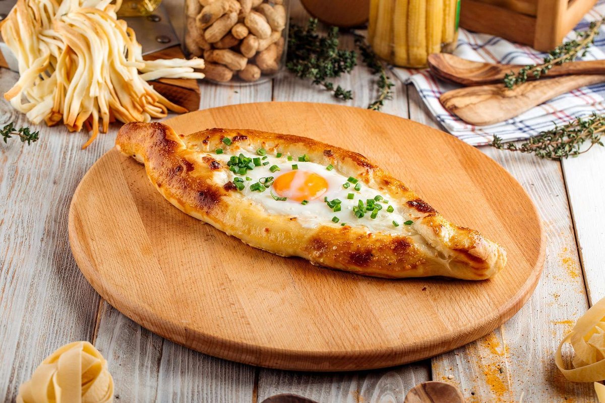 Adjarian khachapuri on a wooden platter