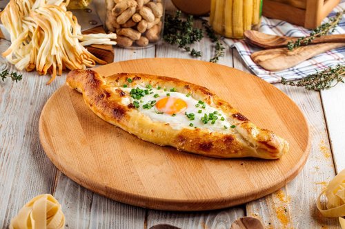 Adjarian khachapuri on a wooden platter