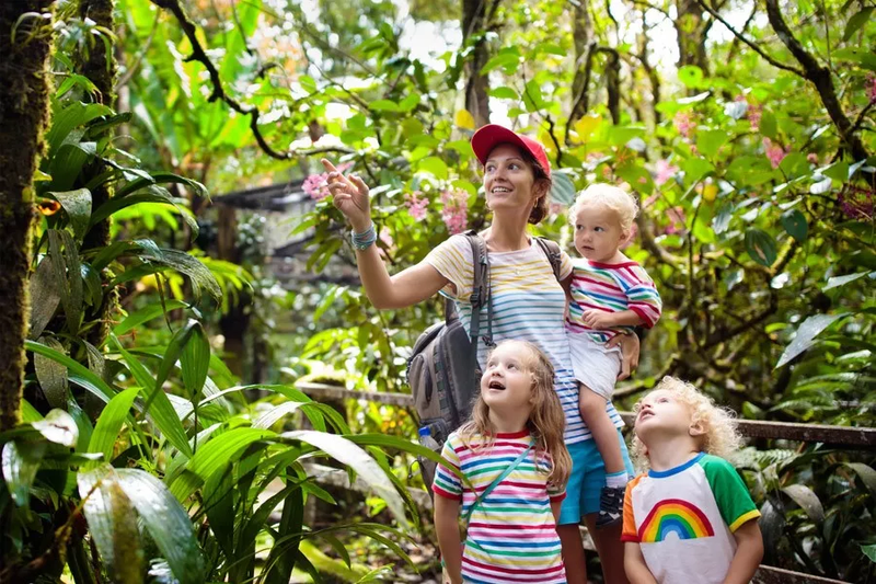 Young woman with children in a tropical forest