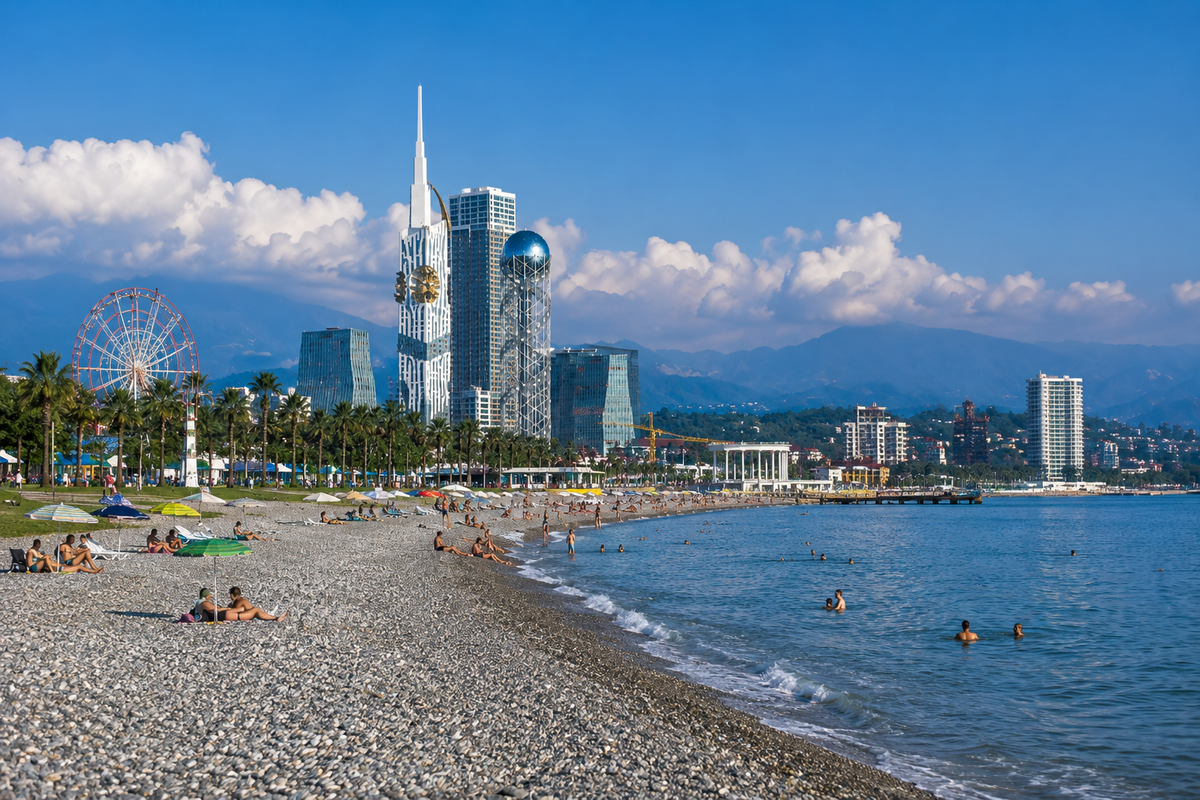 A sunny view of Batumi’s long pebble beach, city skyline and Black Sea.
