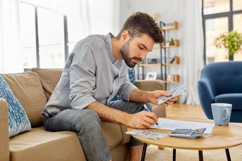 a man with money and a calculator