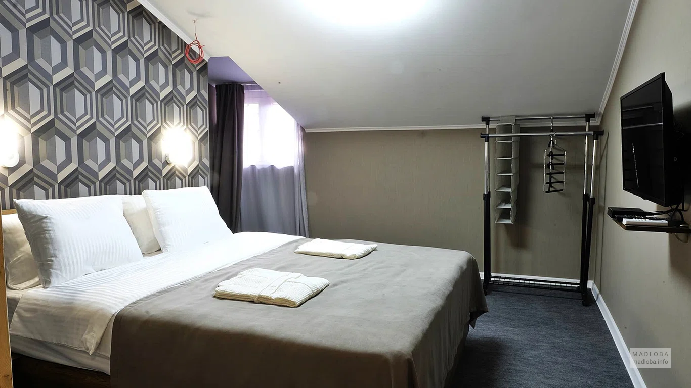 Кровать в номере отеля Cocosha