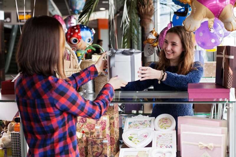 A girl in a souvenir shop buys a gift