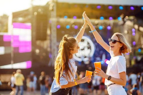Two girls are having a great time at a music festival