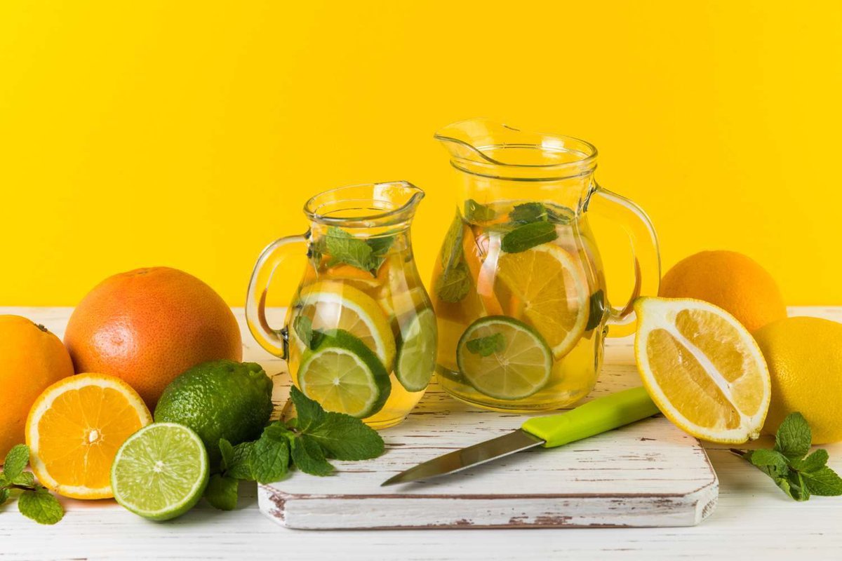 Homemade lemonade pitchers with a yellow background