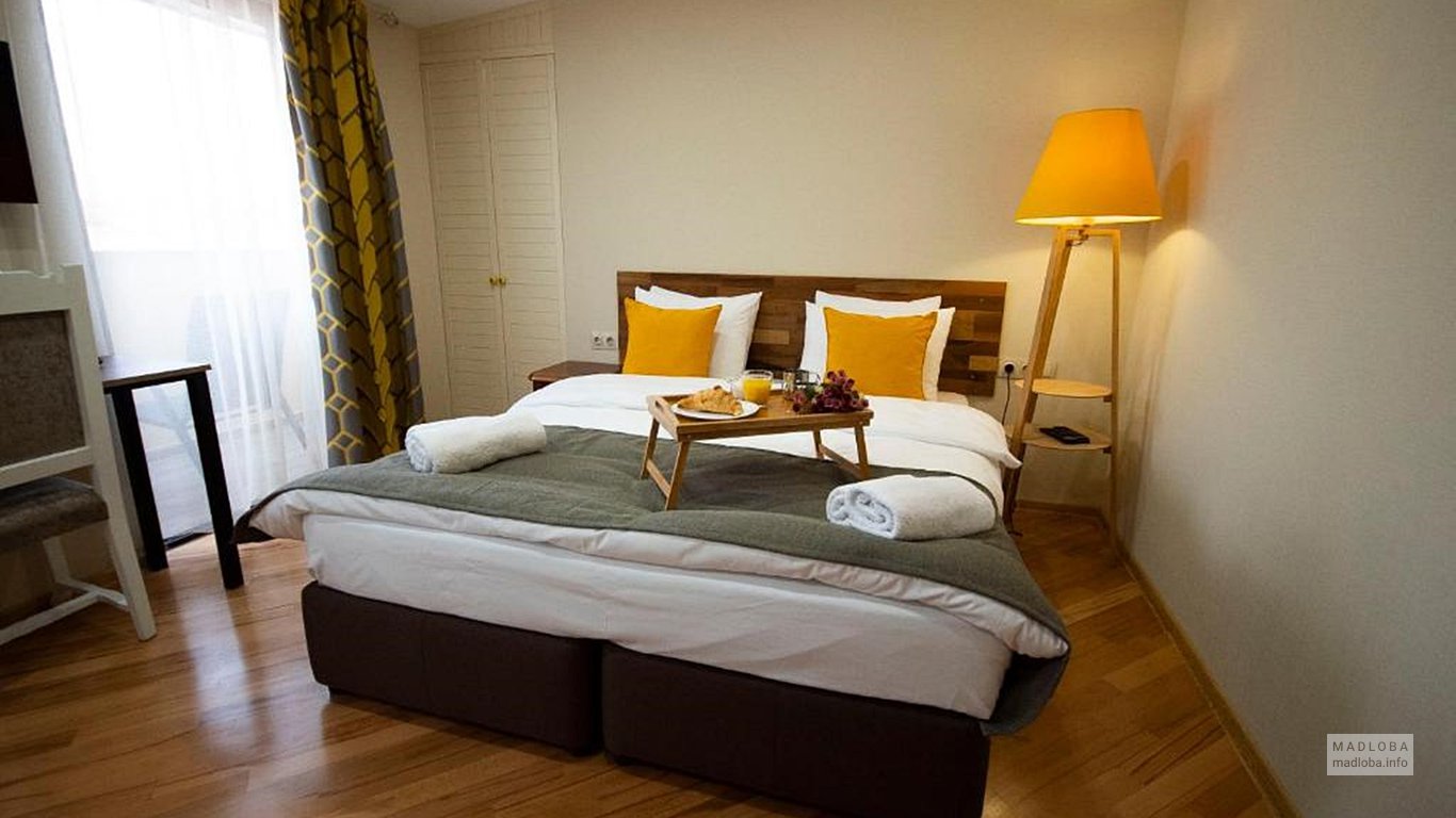Кровать в номере отеля Cordata
