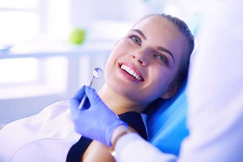 A girl in a chair at a dentist's appointment