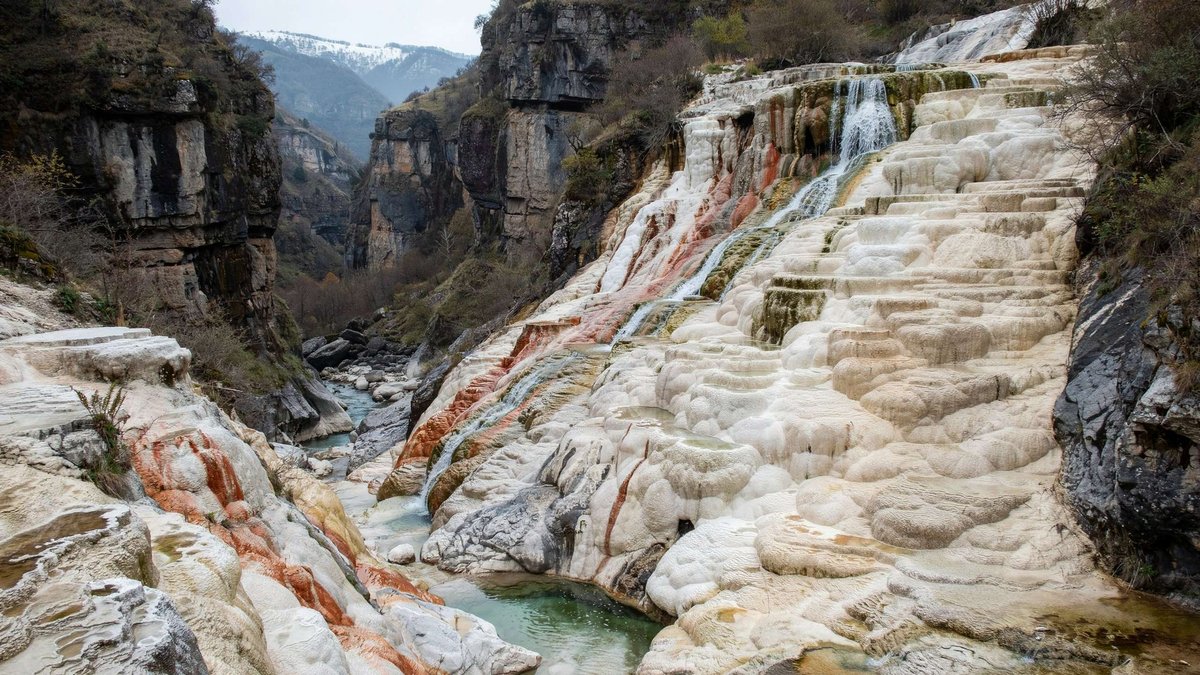 Discover the Narzan Valley in Kasriskhevi Gorge, where more than sixty mineral springs create colorful travertine terraces and one of Georgia's most unusual landscapes.