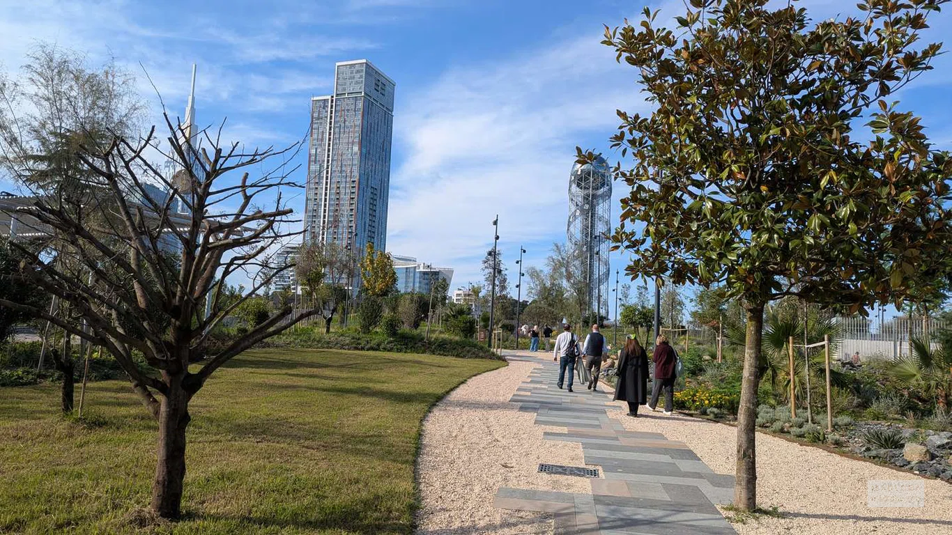 Прогулочная аллея ведёт к побережью, открывая панораму на небоскрёбы и Алфавитную башню Батуми.