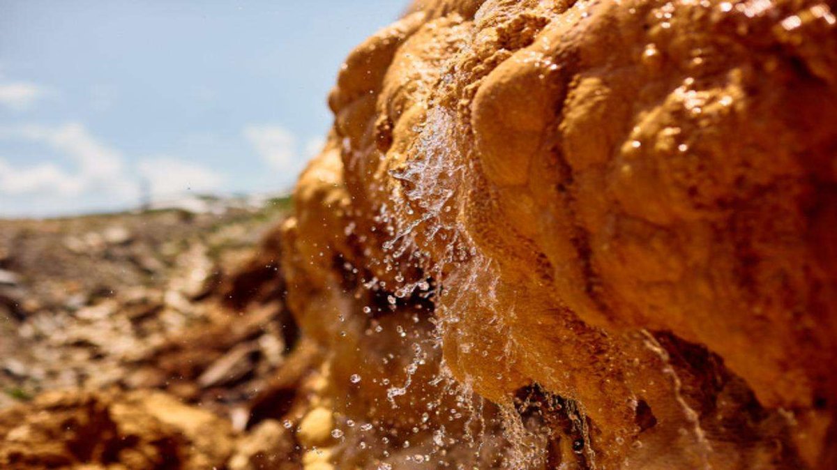 Pure mineral water flows down the stone