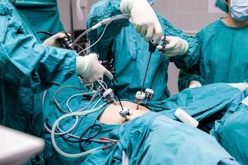 A team of surgeons performs an operation