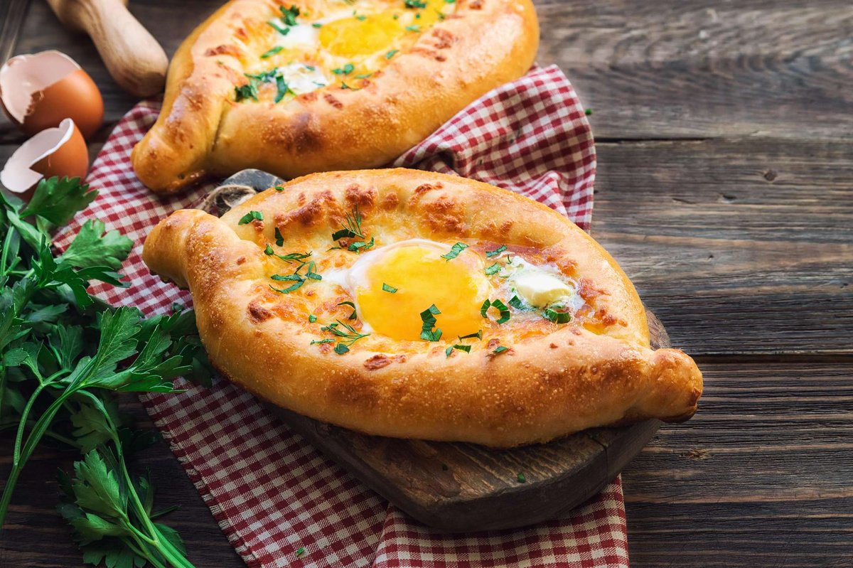 Two Adjarian khachapuri on a towel