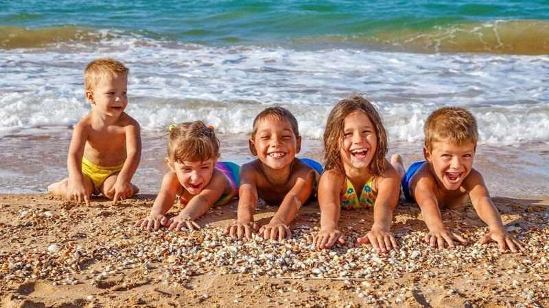 Children are lying on the sand