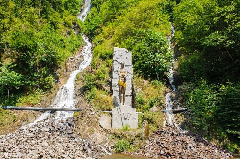 The Prometheus monument against the backdrop of waterfalls in Borjomi National Park