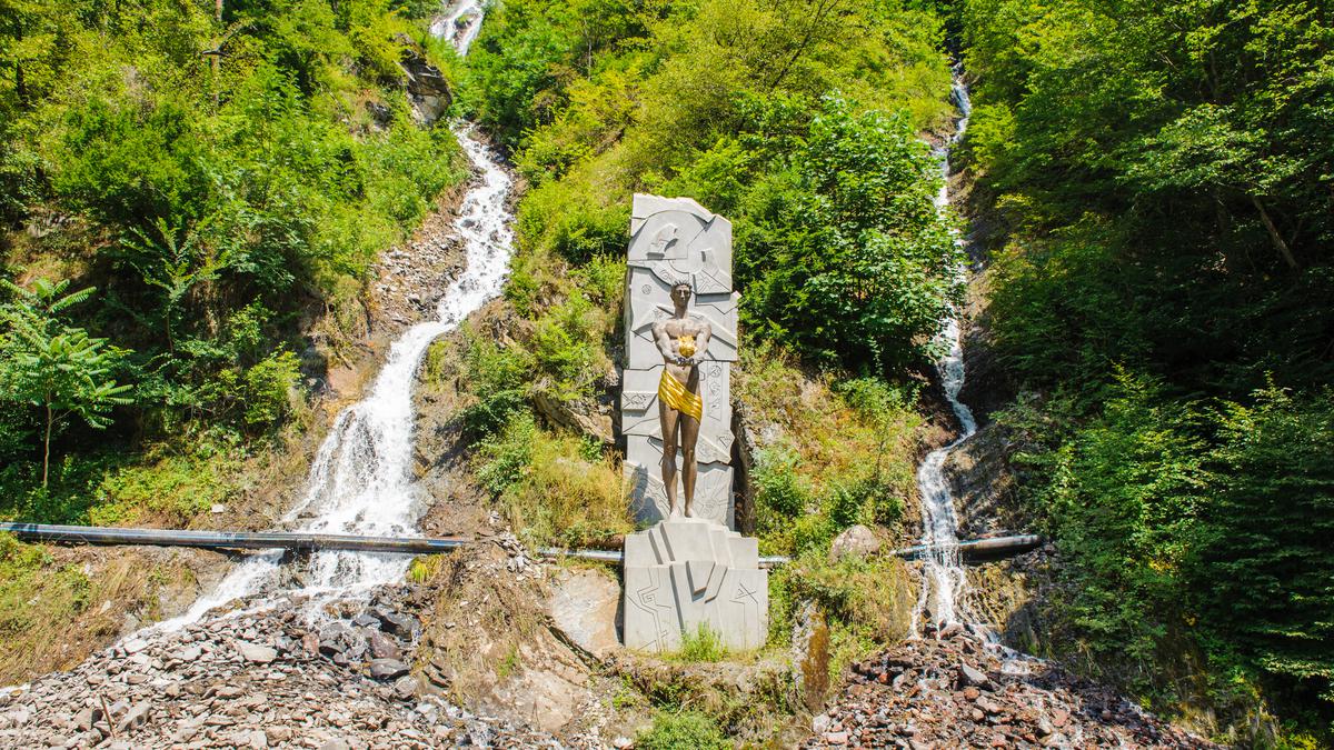 Памятник Прометею на фоне водопадов в Национальном парке Боржоми