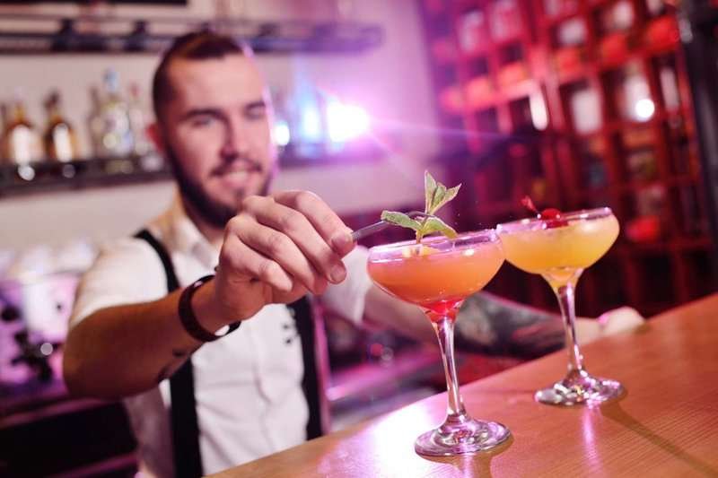 the bartender is preparing a cocktail
