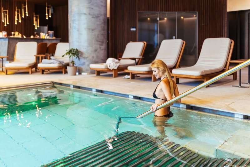 A woman prepares to relax in a hotel spa area