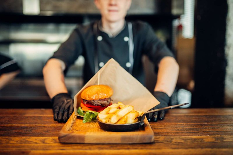 Chef with a ready-made burger