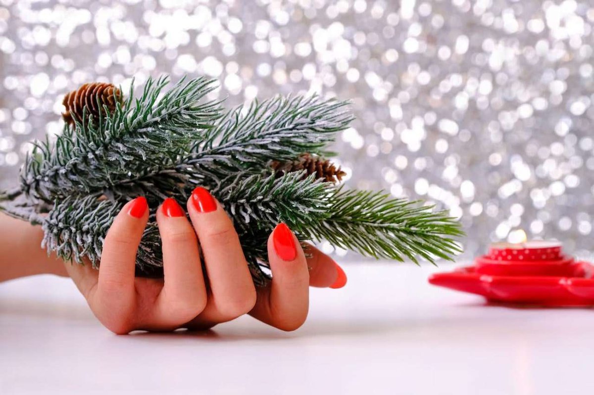 female-hands-there-is-fir-branch-burning-candle-nearby-christmas-decoration.jpg