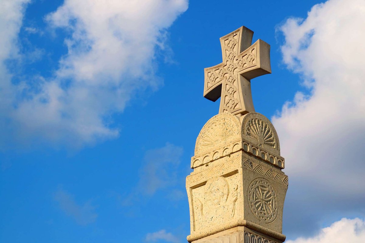 gorgeous-stone-carving-cross-pillar-against-sun