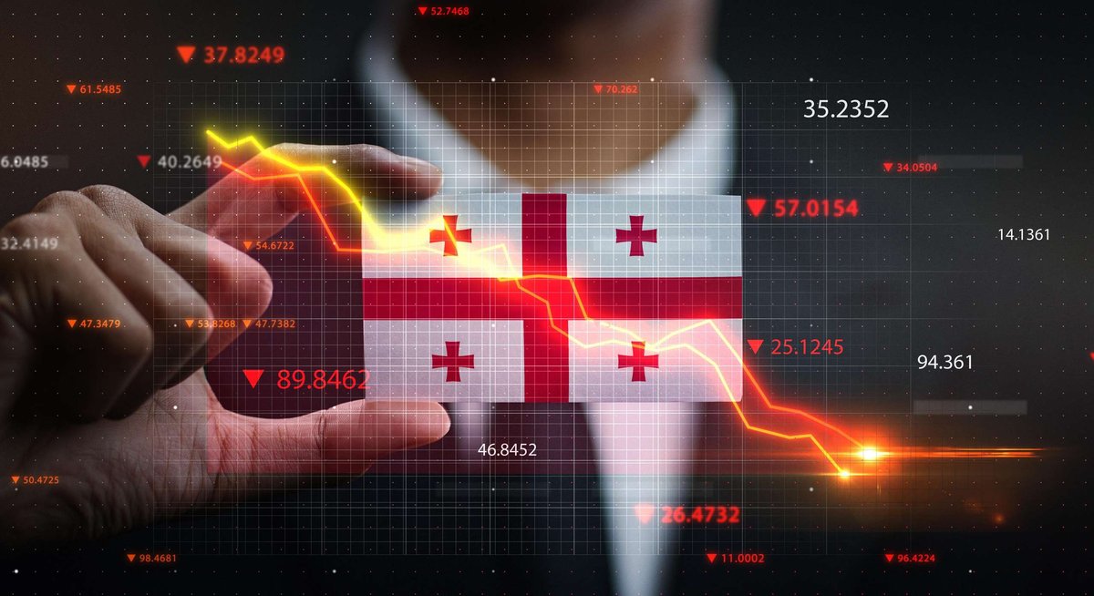 graph-falling-down-in-front-of-georgia-flag-cri.original