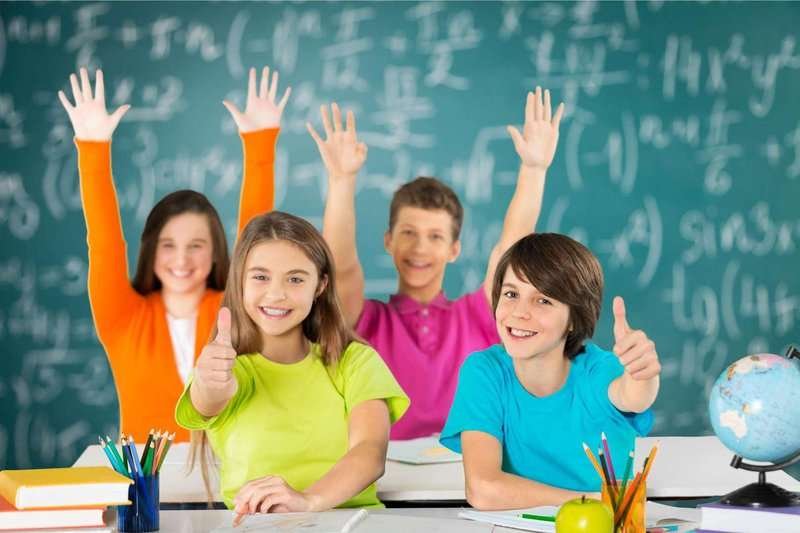 group-of-school-kids-in-classroom-with-hands.max-800x600
