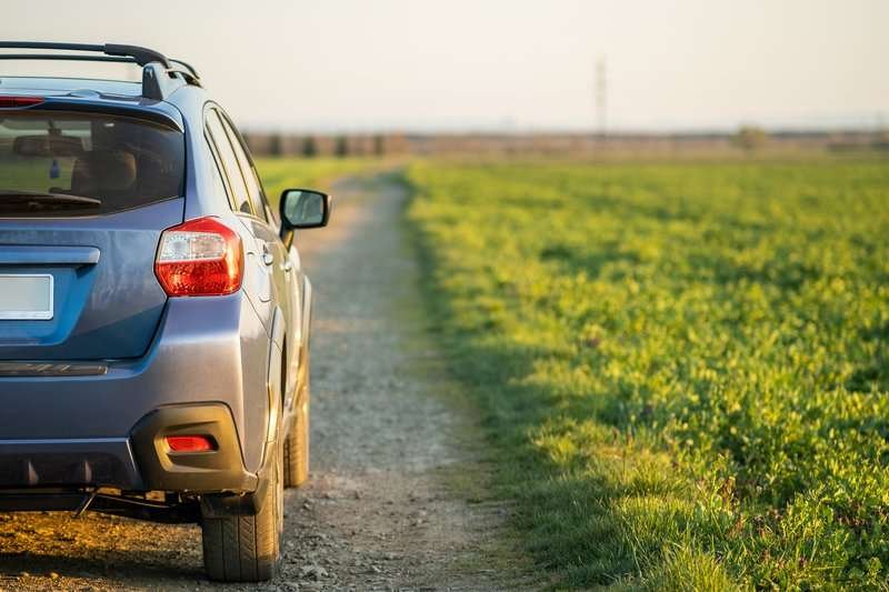 landscape with blue off road car on gravel