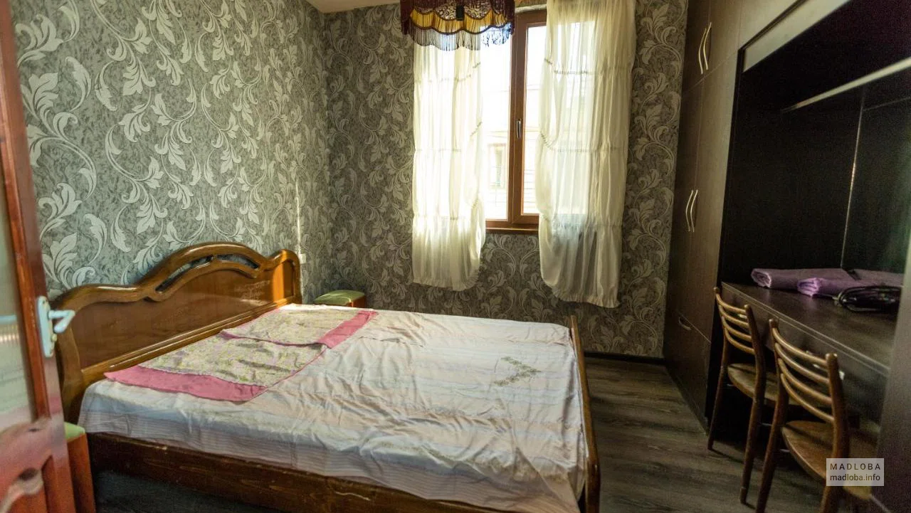 Кровать в номере отеля M House в Тбилиси