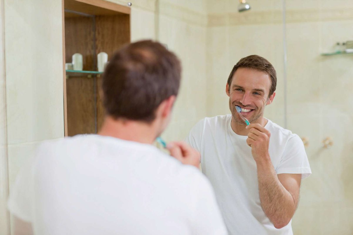 Мужчина чистит зубы