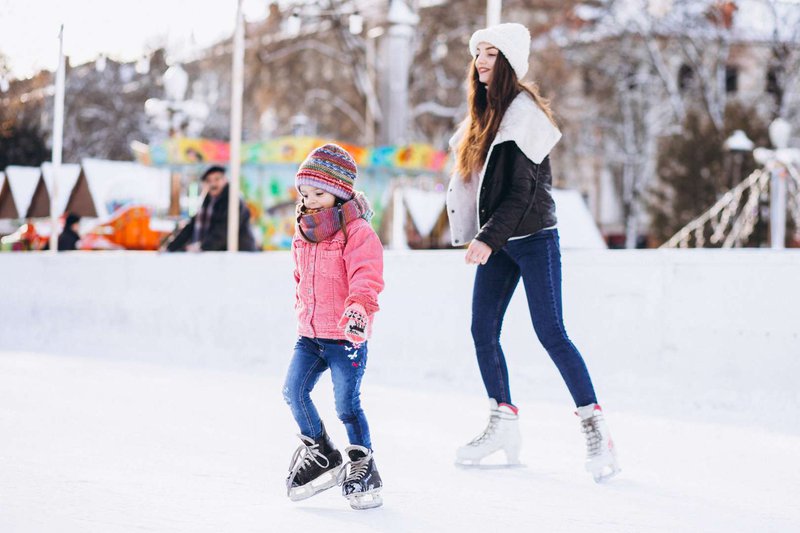 mother-with-daughter-teaching-ice-skating-rink.jpg