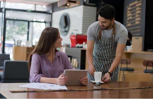 A waiter at a cafe asks to share impressions of a visit to the establishment on Google Maps