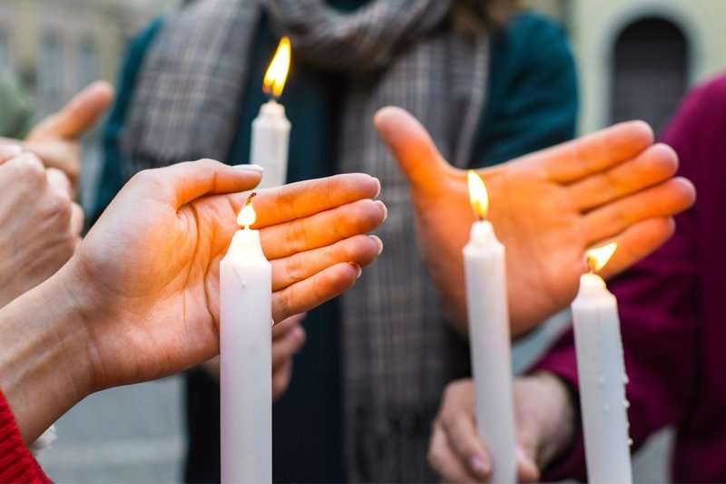 Lighting candles at gravestones on Easter Monday