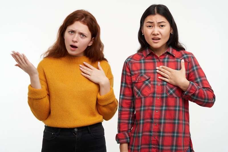Two girls are unhappy about something.