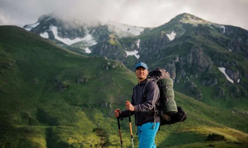 a tourist goes hiking along a mountain route