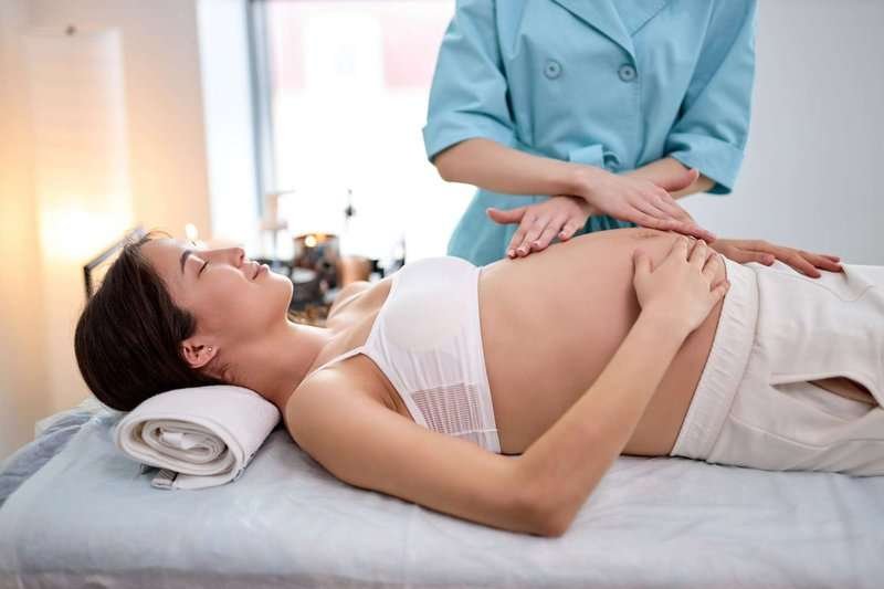 A pregnant woman receiving a massage