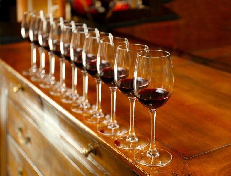 row glasses with red wine bar counter