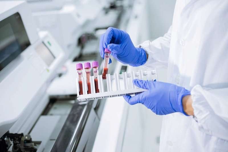 scientist-wear-glove-holding-test-tube-in-sa.max-800x600