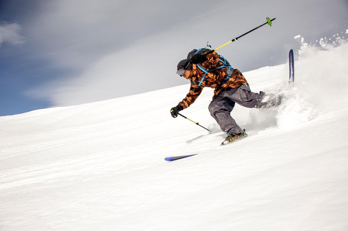 skier-colorful-sportswear-runs-down-mountain-with-ski-ski-sticks.jpg