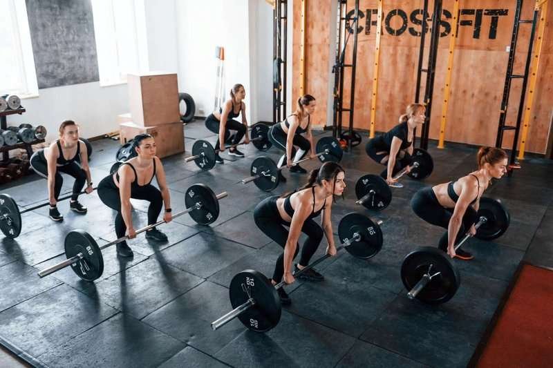 girls training with barbells in the gym