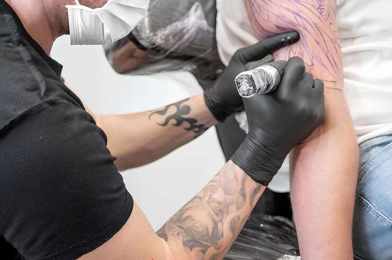 tattoo-artist-working-tattoo