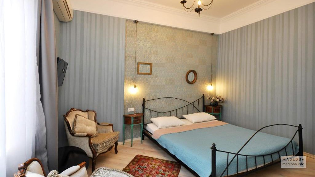 Кровать в номере Бутик-отеля "Террас Гарден"