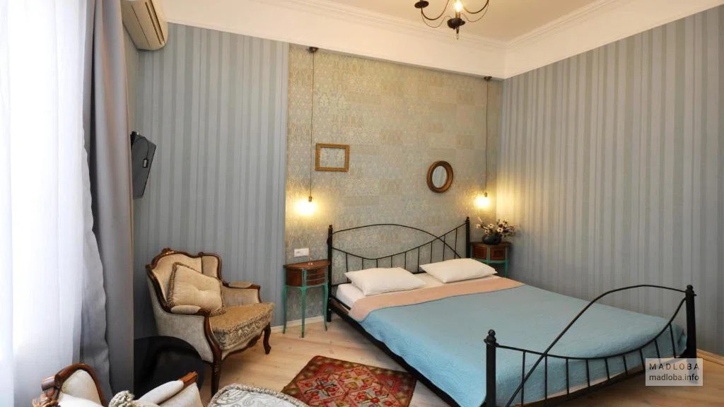 Кровать в номере Бутик-отеля "Террас Гарден"