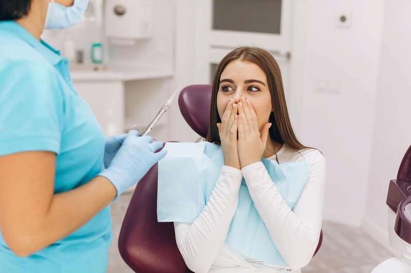 the dentist injects anesthesia to the girl