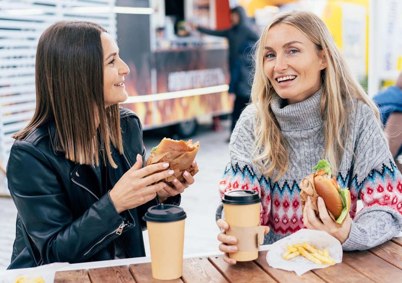 Two women eating fast food