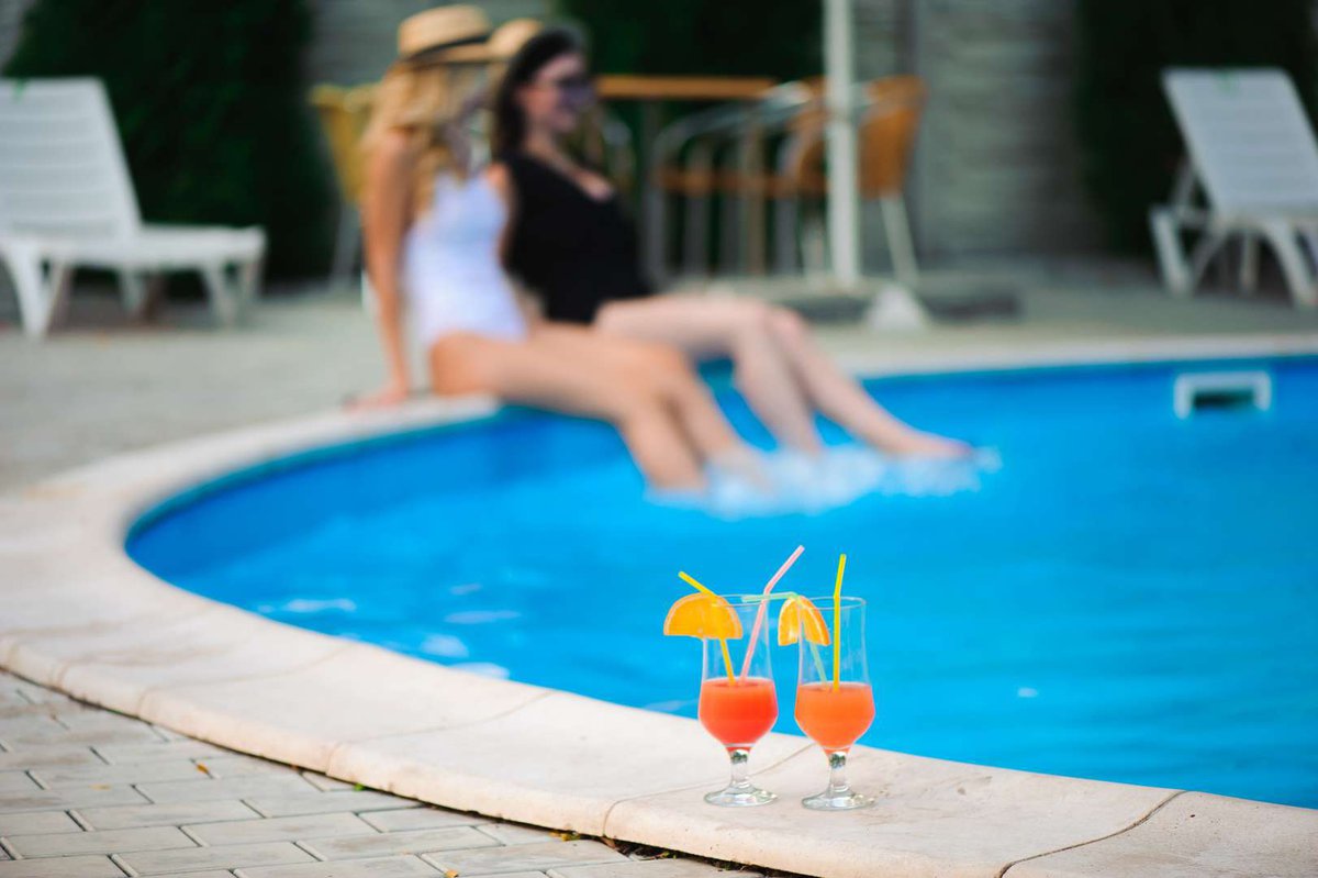Two women relax by the pool